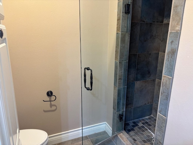 bathroom featuring walk in shower, toilet, and tile patterned flooring