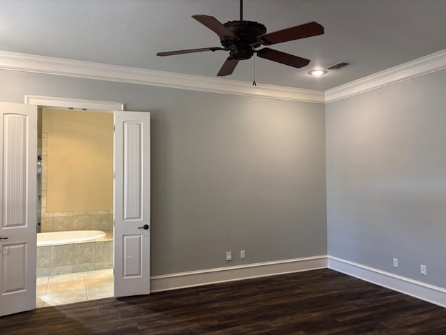 empty room with crown molding, dark hardwood / wood-style floors, and ceiling fan