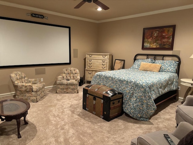 home theater room featuring ornamental molding, light colored carpet, and ceiling fan