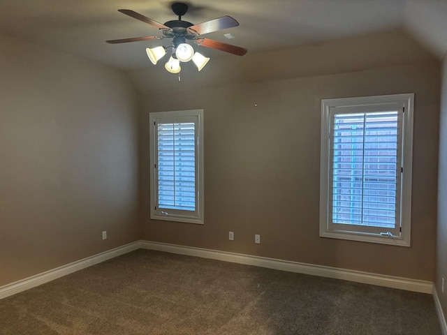 carpeted spare room with vaulted ceiling and ceiling fan