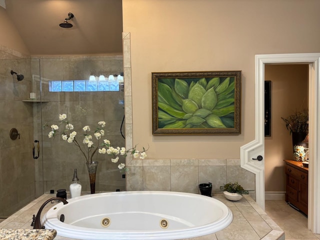 bathroom featuring independent shower and bath, vaulted ceiling, and tile patterned flooring