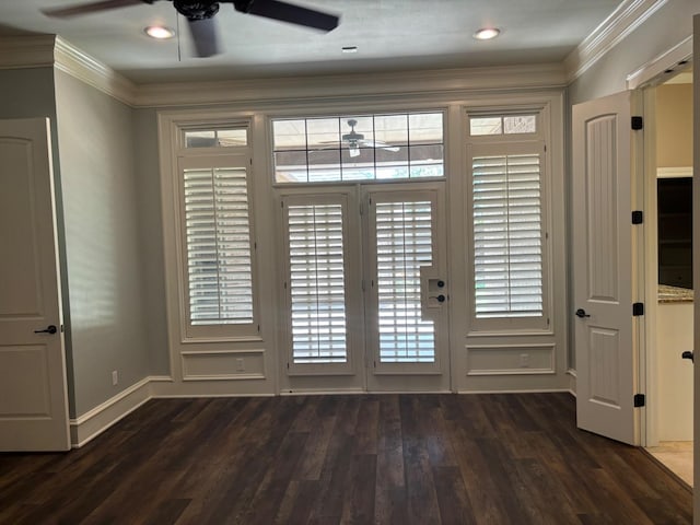 doorway with crown molding, dark wood-type flooring, and ceiling fan