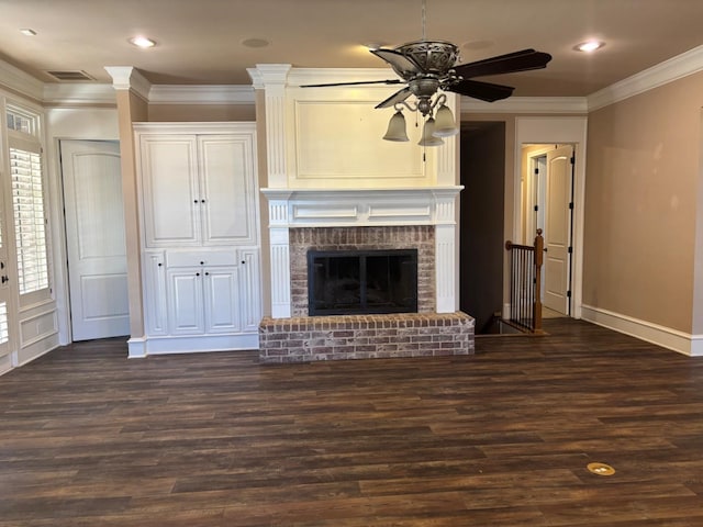 unfurnished living room featuring ornamental molding, a brick fireplace, dark wood-type flooring, and ceiling fan