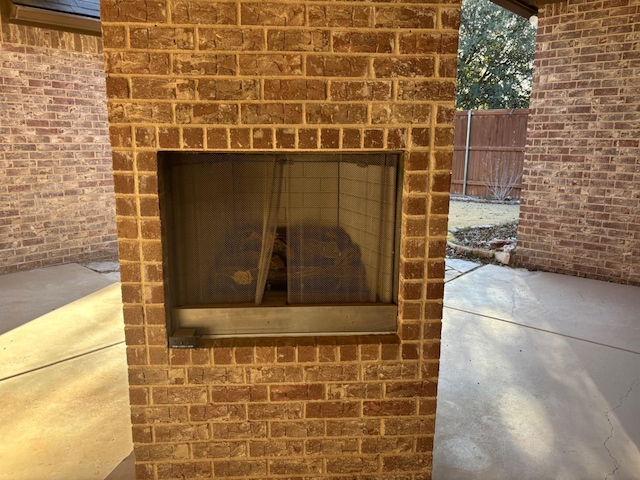 details featuring an outdoor brick fireplace