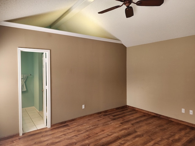 unfurnished room featuring vaulted ceiling with beams, ceiling fan, a textured ceiling, and wood finished floors