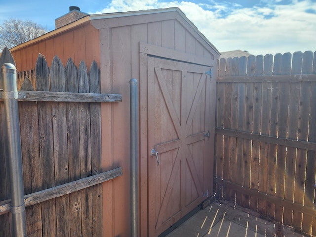 view of shed featuring fence