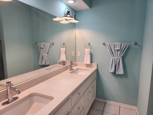 bathroom with double vanity, a sink, and tile patterned floors