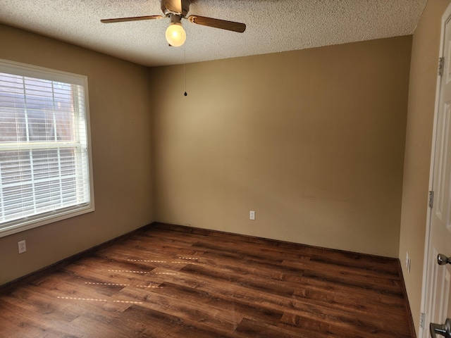 empty room with dark wood-style floors, ceiling fan, and a textured ceiling