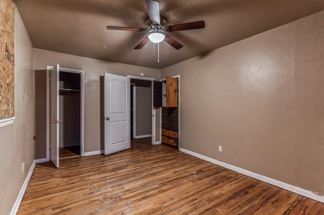 unfurnished bedroom featuring wood-type flooring, ceiling fan, and a closet