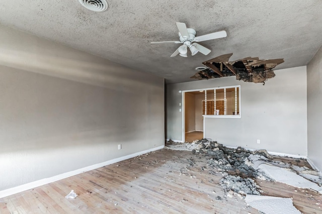 interior space featuring wood-type flooring, a textured ceiling, and ceiling fan