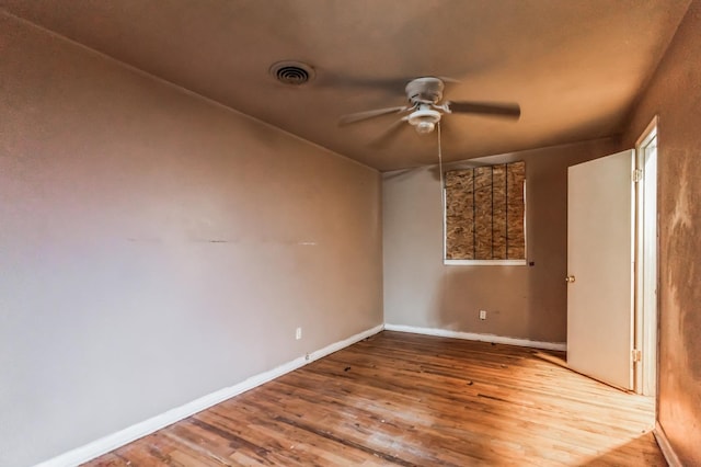 empty room with ceiling fan and wood-type flooring