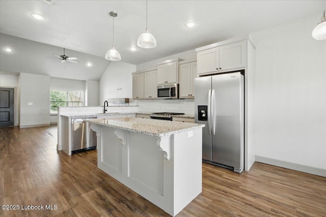 10330 Ave X Ave, Lubbock, TX 79423 - kitchen featuring appliances with stainless steel finishes, a peninsula, a ceiling fan, a center island, and dark wood finished floors