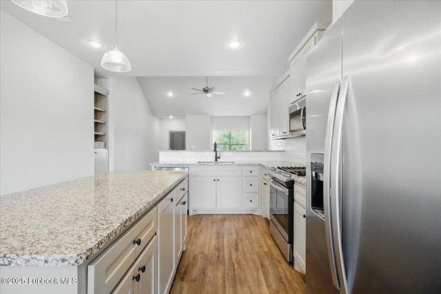 10330 Ave X Ave, Lubbock, TX 79423 - kitchen with appliances with stainless steel finishes, light wood-style flooring, ceiling fan, white cabinets, and recessed lighting