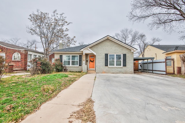 view of front of house with a front yard and a carport