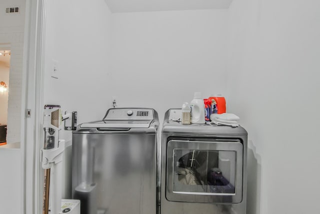 clothes washing area with washing machine and clothes dryer