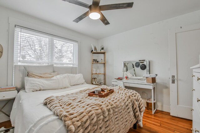 bedroom with ceiling fan and light hardwood / wood-style flooring