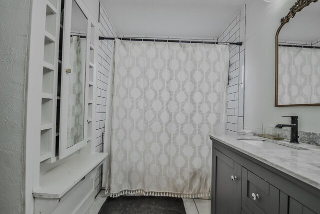 bathroom featuring tile patterned flooring and vanity