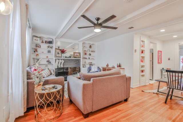 living room featuring wood-type flooring, built in features, and ceiling fan