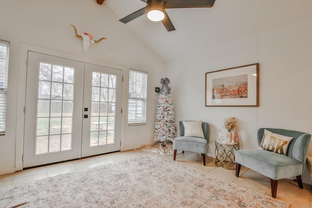 living area featuring light tile patterned floors, vaulted ceiling, french doors, and ceiling fan