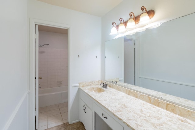 bathroom with tiled shower / bath, vanity, and tile patterned floors