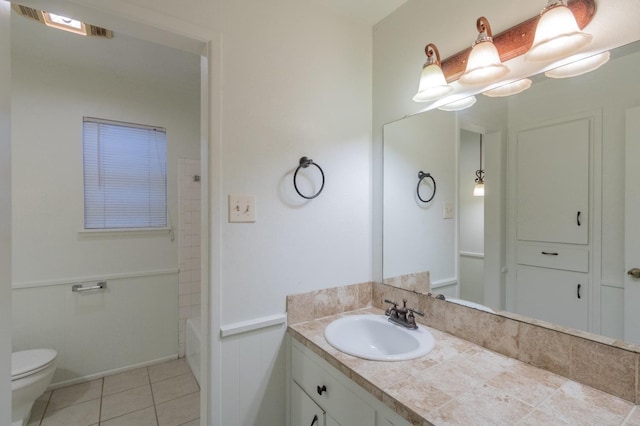 bathroom featuring vanity, toilet, and tile patterned flooring