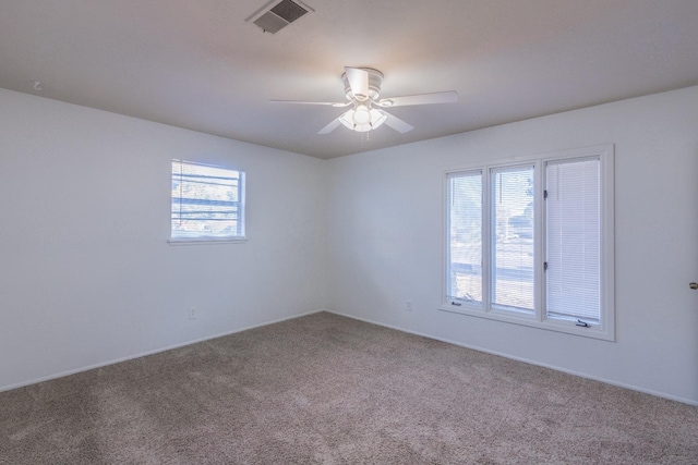 spare room with carpet flooring and ceiling fan