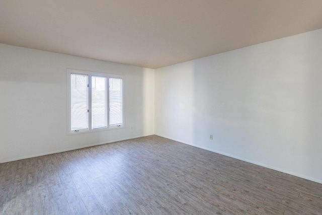 spare room with hardwood / wood-style flooring