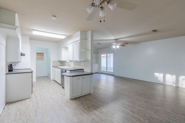 kitchen featuring sink, tasteful backsplash, range with electric stovetop, light hardwood / wood-style floors, and white cabinets