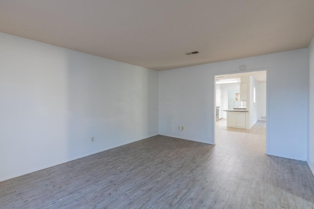 unfurnished room with light hardwood / wood-style floors