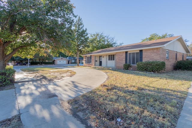 ranch-style home featuring a garage and a front lawn