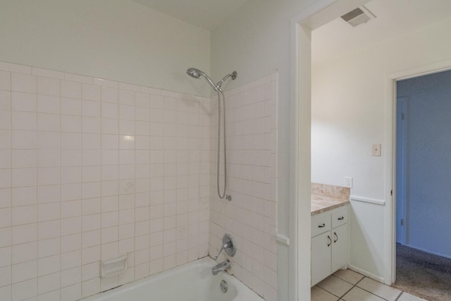 bathroom with vanity, tile patterned flooring, and tiled shower / bath combo