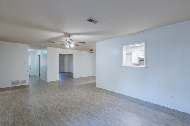 spare room with hardwood / wood-style floors and ceiling fan