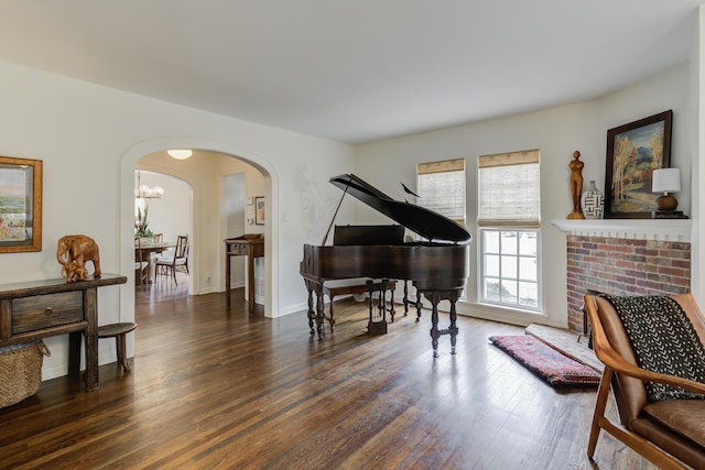 3003 19th St, Lubbock, TX 79410 - sitting room with arched walkways, wood finished floors, and a chandelier
