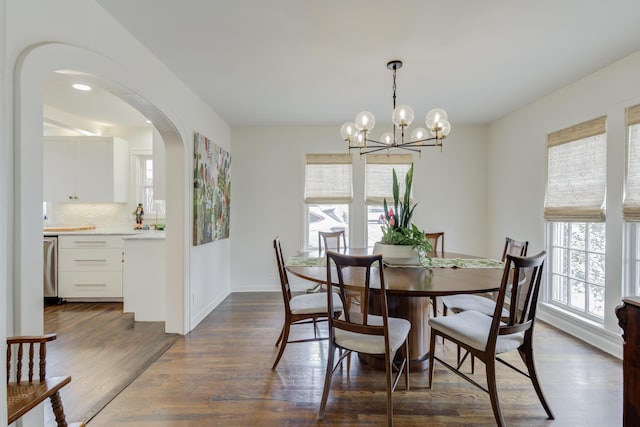 3003 19th St, Lubbock, TX 79410 - dining space with arched walkways, dark wood-type flooring, and a chandelier