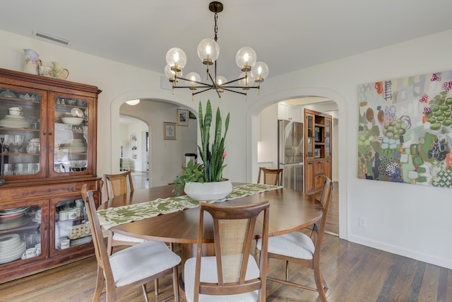3003 19th St, Lubbock, TX 79410 - dining area with arched walkways, wood finished floors, and a chandelier