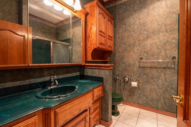 bathroom with vanity, toilet, a shower with shower door, and tile patterned flooring