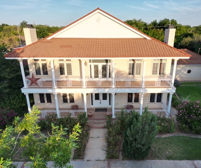 view of front facade featuring a balcony and covered porch