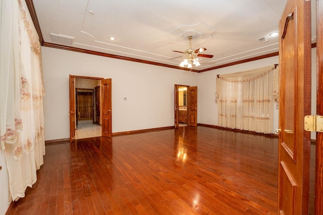 empty room with hardwood / wood-style floors, ornamental molding, and ceiling fan