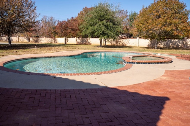 view of pool with an in ground hot tub and a patio