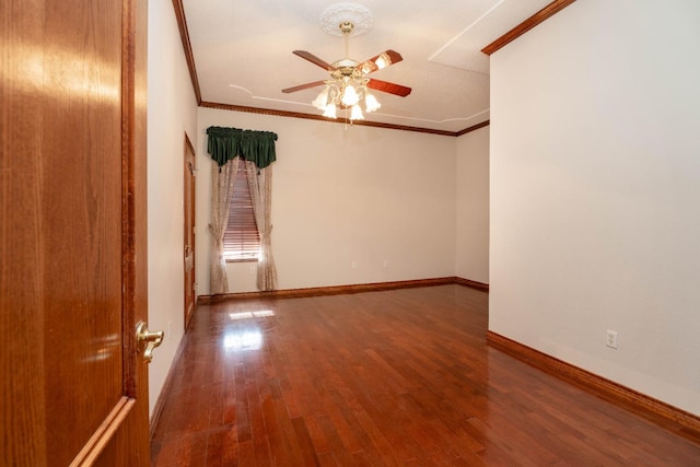 empty room with ceiling fan, ornamental molding, and hardwood / wood-style floors