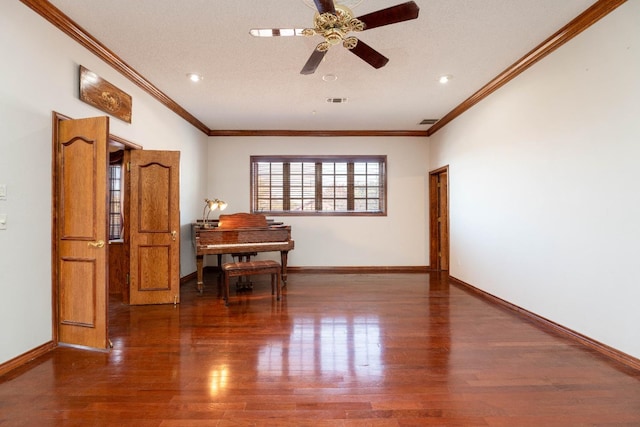 empty room featuring ornamental molding, a textured ceiling, ceiling fan, and dark hardwood / wood-style flooring