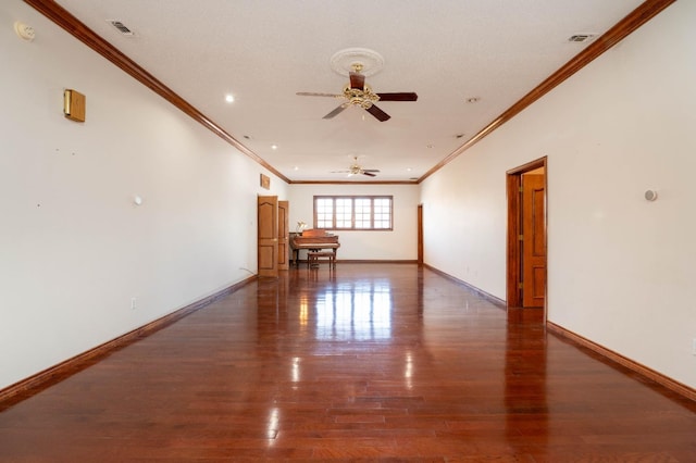 empty room with crown molding, dark hardwood / wood-style floors, and ceiling fan