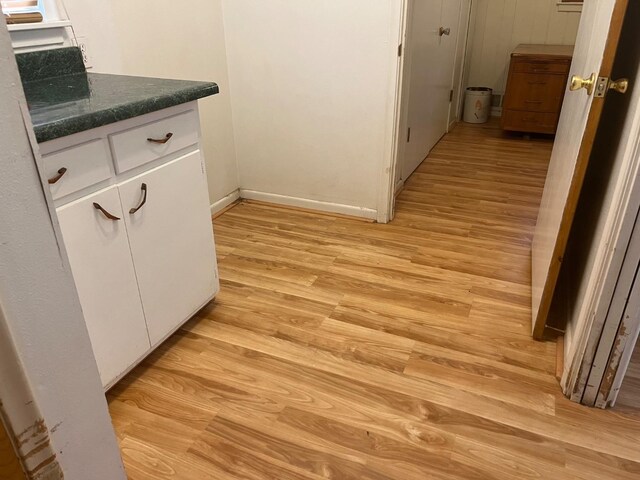 interior space featuring white cabinets and light wood-type flooring