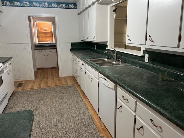 kitchen featuring white dishwasher, sink, white cabinetry, and light hardwood / wood-style flooring