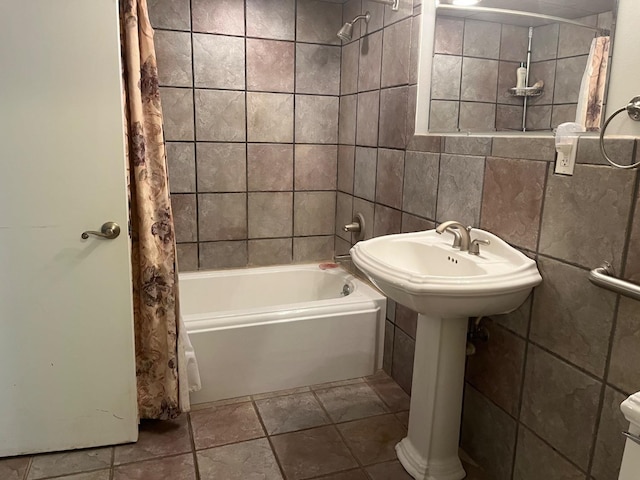 bathroom featuring shower / tub combo and tile walls