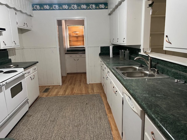 kitchen with sink, white cabinets, white appliances, and light wood-type flooring