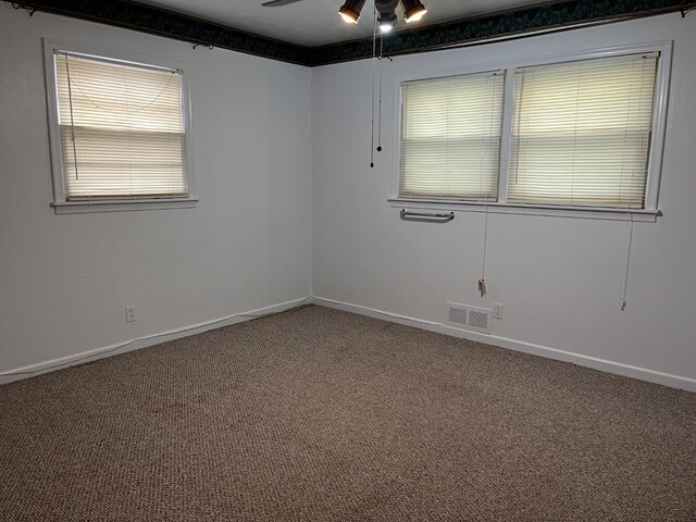 carpeted empty room featuring ceiling fan