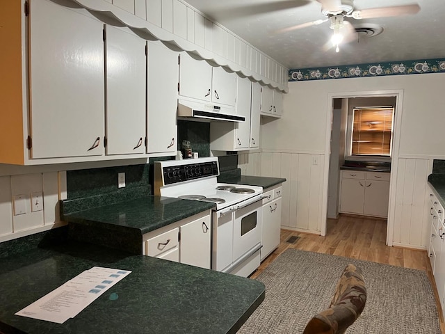 kitchen with double oven range, ceiling fan, white cabinets, and light wood-type flooring