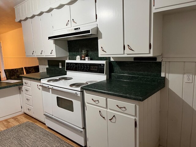 kitchen featuring white cabinetry, decorative backsplash, light hardwood / wood-style floors, and range with two ovens