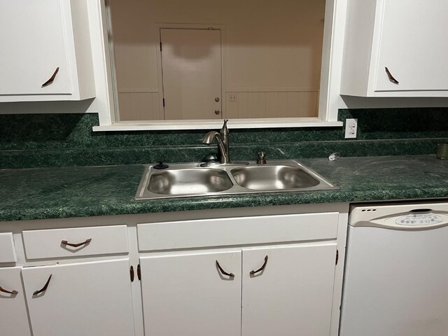 kitchen featuring sink, white cabinets, and white dishwasher